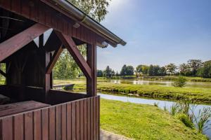 a house with a view of a river at Łowisko Dom ze Stawami in Trudna