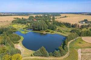 an aerial view of a lake in the countryside at Łowisko Dom ze Stawami in Trudna +9 photos