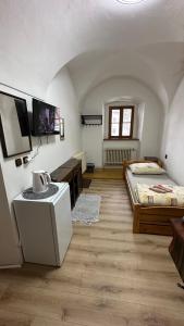 a large room with two beds and a tv at Penzion Nattali in Poprad
