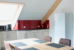 a kitchen with a table and a refrigerator at Fuchs at home in Kaltbrunn