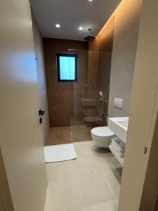 a bathroom with a toilet and a sink at EFFÉI Boutique Hotel in Sarandë +177 photos