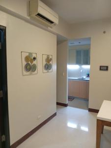 a room with a white wall with two pictures on it at Condo in Mactan Newtown in Lapu Lapu City