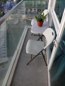 a table and chairs on a balcony with a plant at Condo in Mactan Newtown in Lapu Lapu City