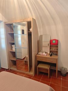 a bedroom with a dressing table and a mirror at Kastri 2 in Kythira
