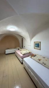 two beds in a room with an attic at Penzion Nattali in Poprad
