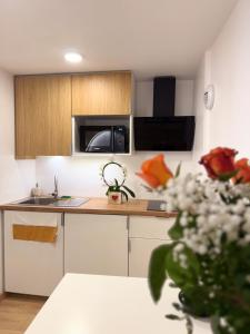 a kitchen with white cabinets and a counter top at Les arches in Riom