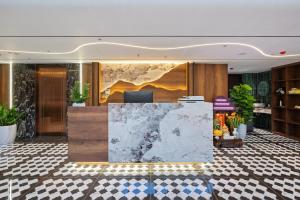 a lobby with a reception desk in a building at MAIA Boutique Hotel Da Nang in Danang +29 photos