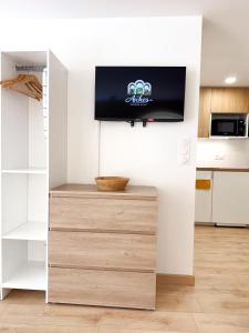 a flat screen tv on a wall in a kitchen at Les arches in Riom