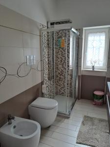 a bathroom with a shower and a toilet and a sink at Le due Rive in Tufo +18 photos