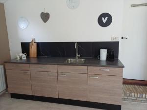 a kitchen with a sink and a counter top at B & B it Heech in Ferwerd