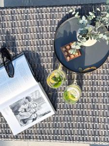 a table with a book and two glasses on it at Studio Bachgeflüster in Schattendorf