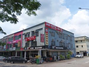 a building with signs on the side of it at Jam Hotel Nilai in Nilai
