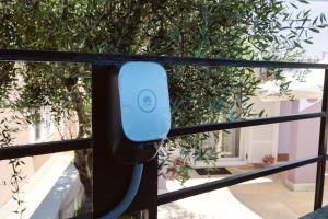 a blue phone is hanging on a window at Apartmani Raić in Mali Lošinj