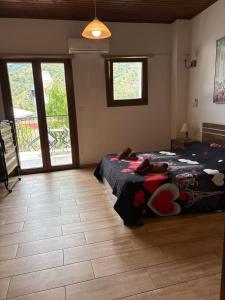 a bedroom with a bed with a comforter on it at Love Holiday Suite 2 in Tris Elies