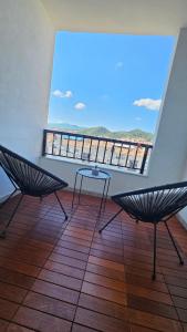 a room with two chairs and a table on a balcony at 007 Apartments - TC Global, Strumica, Macedonia in Strumica