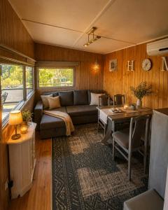 a living room with a couch and a table at Domek Panorama in Rymanów-Zdrój