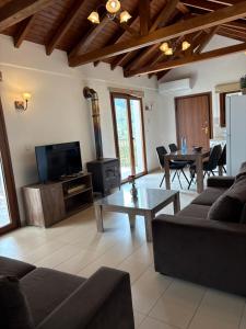a living room with a couch and a tv and a table at Love Holiday Suite 2 in Tris Elies
