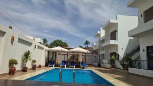 a villa with a swimming pool and two buildings at Malak house swimming pool &Garden in Luxor