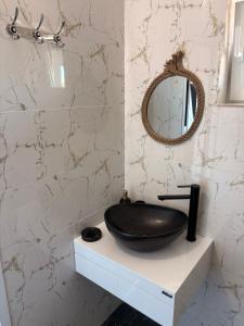a bathroom with a black sink and a mirror at SummerBlue - Синьо лято in Lozenets