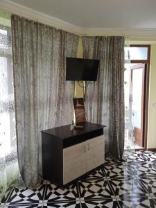 a living room with a dresser with a lamp on it at Shekvetili Babi in Shekhvetili