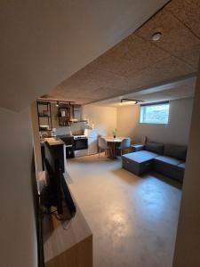 a living room with a couch and a tv at Lofoten Apartment 01 in Leknes