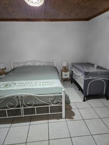 a bedroom with a bed and a piano in it at Olive garden cottage, Krines in Vélon