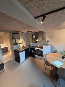 a kitchen with white appliances and a table in it at Lofoten Apartment 01 in Leknes