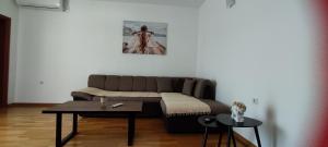 a living room with a couch and a table at Tamaris apartments Risan in Risan