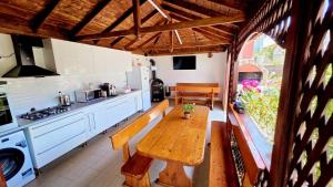 a kitchen with a wooden table in a kitchen at Casa Nicola in 2 Mai +38 photos