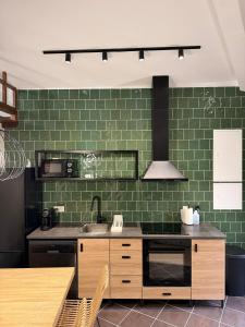 a kitchen with a sink and green tiles at Casa D'Avó Carmen in Ventosa