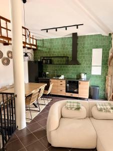 a kitchen and dining room with a couch and a table at Casa D'Avó Carmen in Ventosa