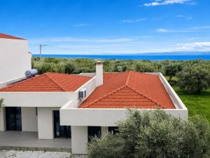 a view of a house with an orange roof at Villa ATLAS relax in Prinos