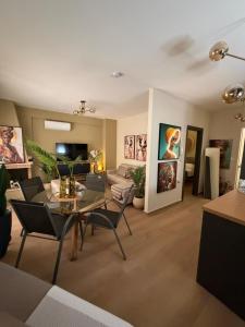 a living room with a table and chairs and a couch at DD apartments & suites in Paralia Katerinis
