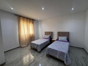 a room with two beds and a window at Horizon yasmine in Yasmine +29 photos