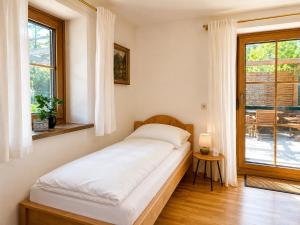 a bed in a room with a window at Landhaus Sisi - River&Pool in Bad Ischl