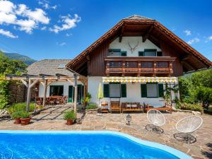 a house with a swimming pool in front of a house at Landhaus Sisi - River&Pool in Bad Ischl
