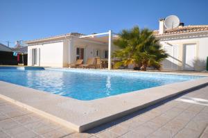 a swimming pool in front of a house at Casa Sol in Aljezur