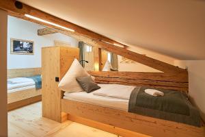 a bedroom with a wooden bed in a room at Forsthaus Valepp in Schliersee