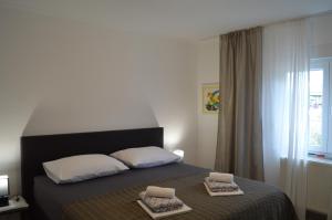 a bedroom with a bed with two towels on it at Marina in Čapljina