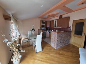 a kitchen and dining room with a table and chairs at Apartment Emir in Mostar +3 photos