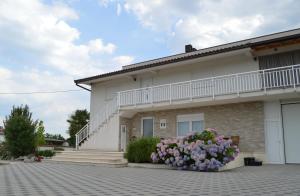 a white house with a flower pot in front of it at Marina in Čapljina