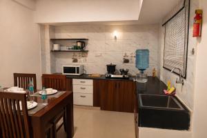 a kitchen with a sink and a counter top at Guest House Suites in Bangalore