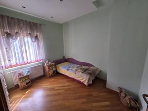 a small room with a bed and two windows at Apartment Emir in Mostar