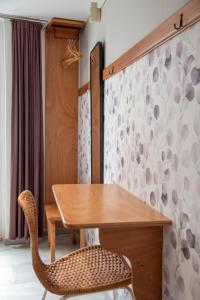a wooden table and a chair in a room at Flora in Tinos +65 photos