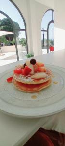 a plate of food with fruit on a table at Hotel Ristorante La Scogliera in Amantea