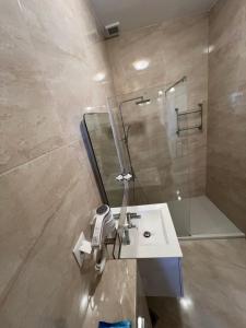 a bathroom with a sink and a shower at Orizon Sea View in Vathi +27 photos