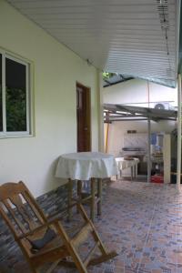 a table and chairs in a living room with a table and chairs at Room 5 in Siquijor