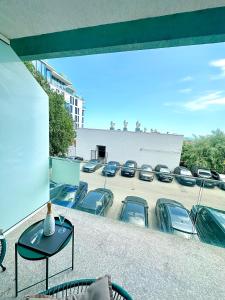 a balcony with a bunch of cars parked in a parking lot at Mario Summerland Property in Mamaia +1 photo