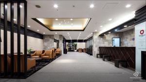 a lobby of a hotel with chairs and a bar at Daiwa Roynet Hotel Kobe Sannomiya in Kobe