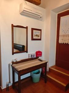 a mirror and a wooden table in a room at Kastri in Kythira